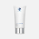 A white tube of exfoliating IS Clinical Warming Honey Cleanser with a silver cap.