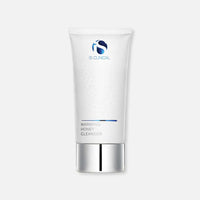A white tube of exfoliating IS Clinical Warming Honey Cleanser with a silver cap.