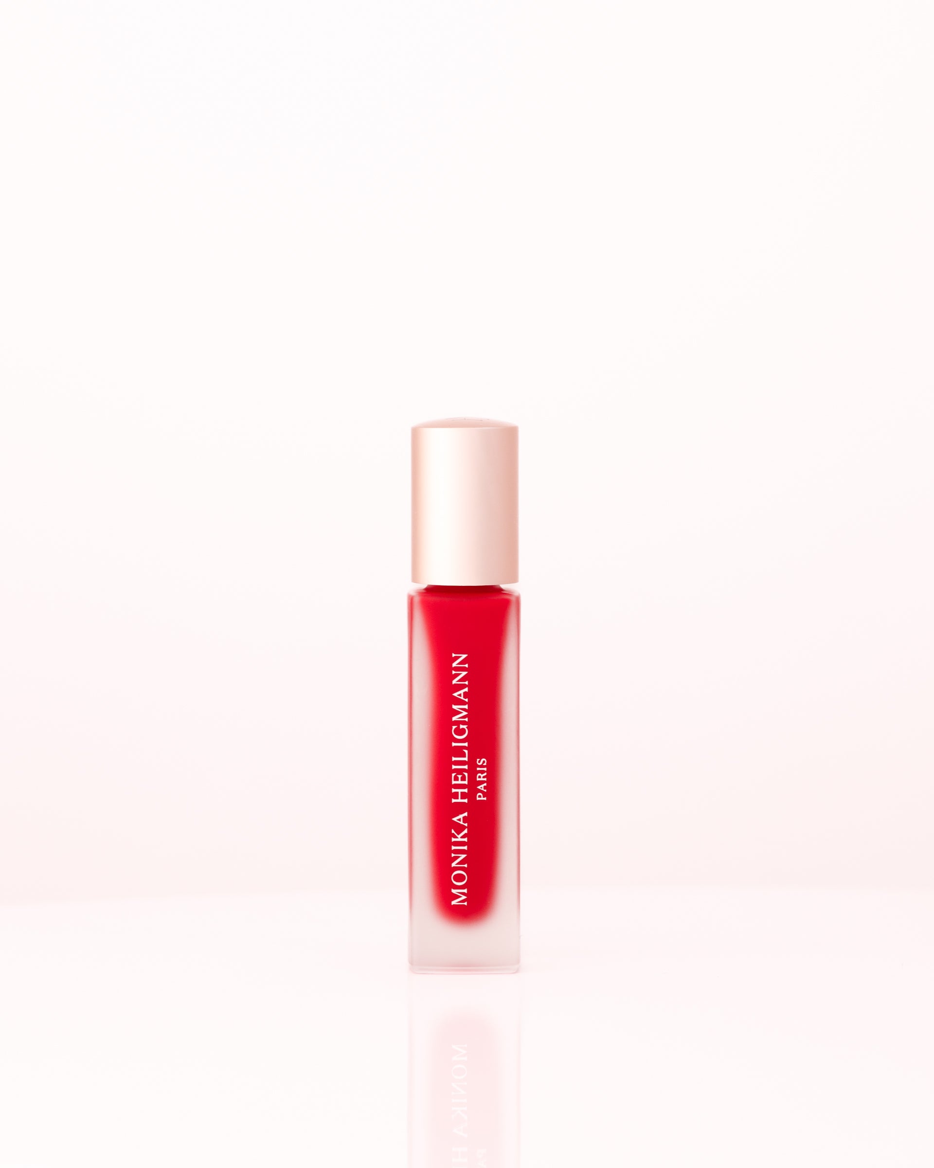 Applying Monika Heiligmann Lips In Love Trio for hydrated, plump, Parisian-inspired lips – available at Amirova